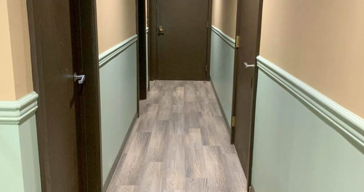 Luxury Vinyl Plank flooring where Each plank fits seamlessly, forming a flawless, uninterrupted expanse that accentuates the corridor's length and sophistication